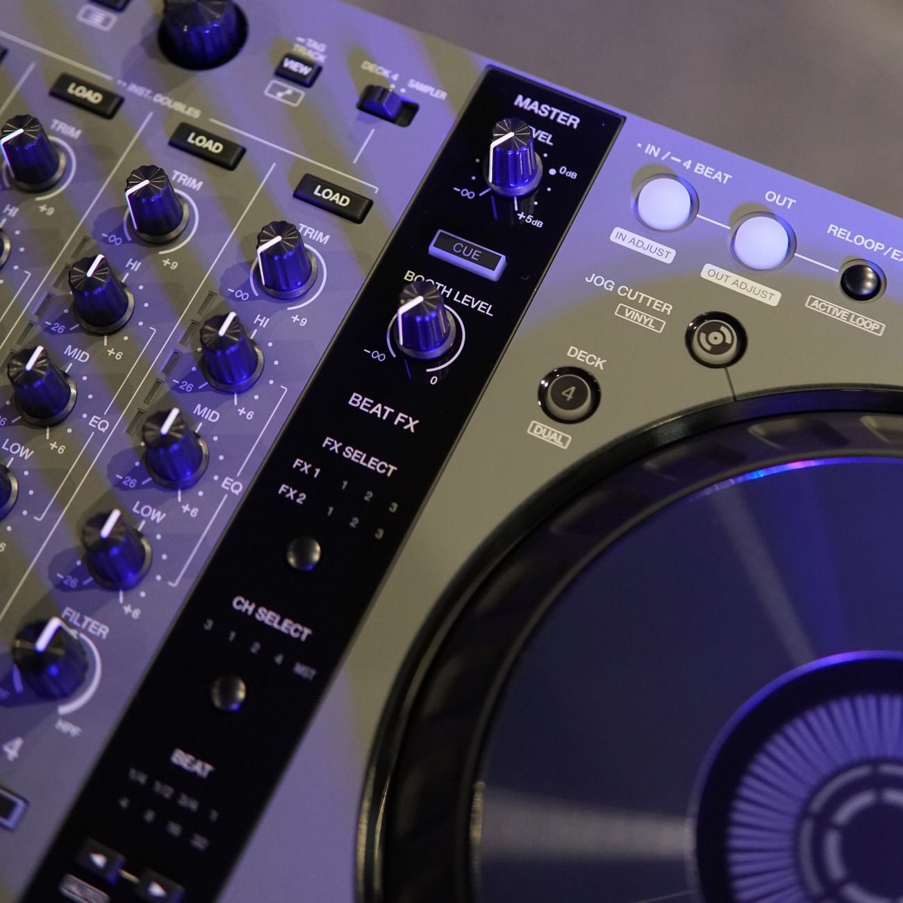 Professional DJ mixer with controls and effects in amber light