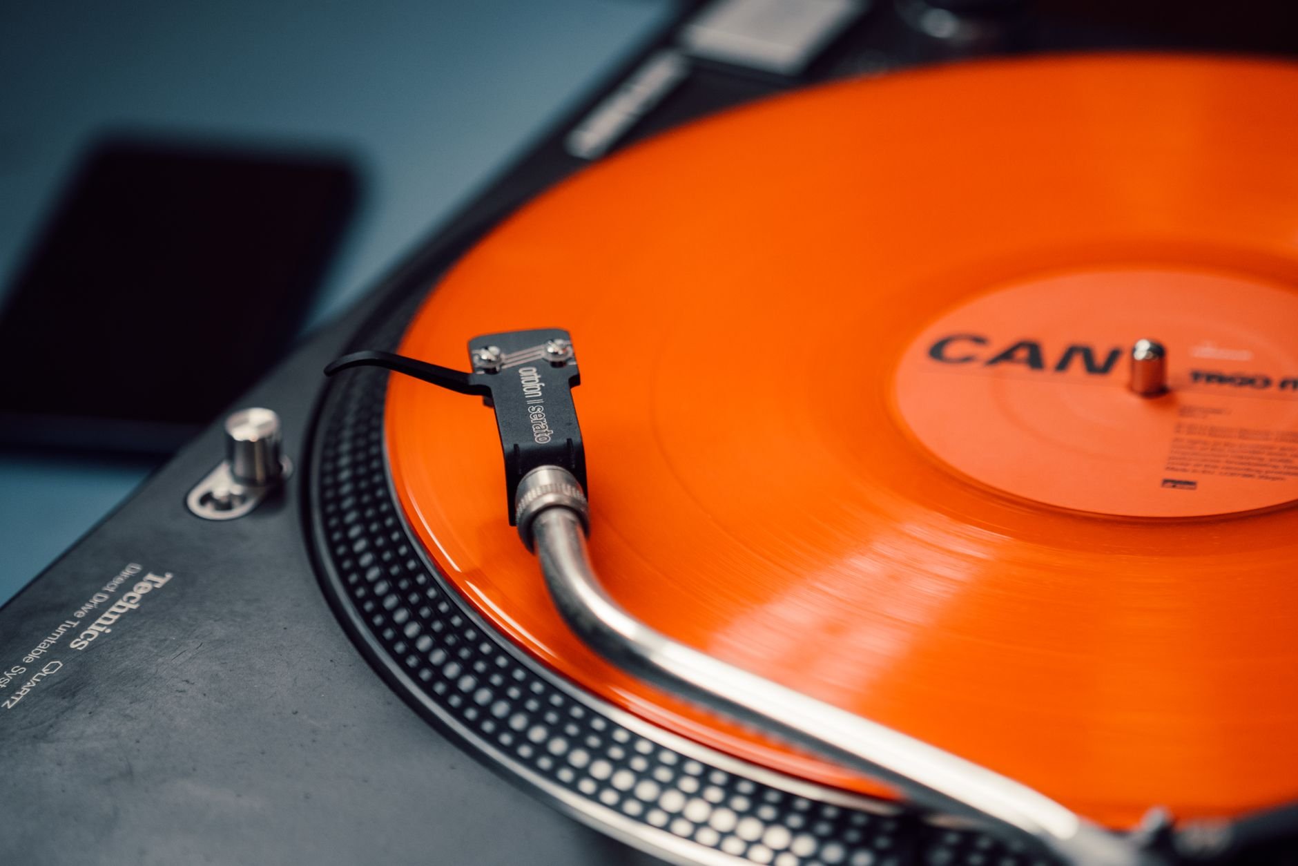 Spinning orange vinyl record on a classic turntable